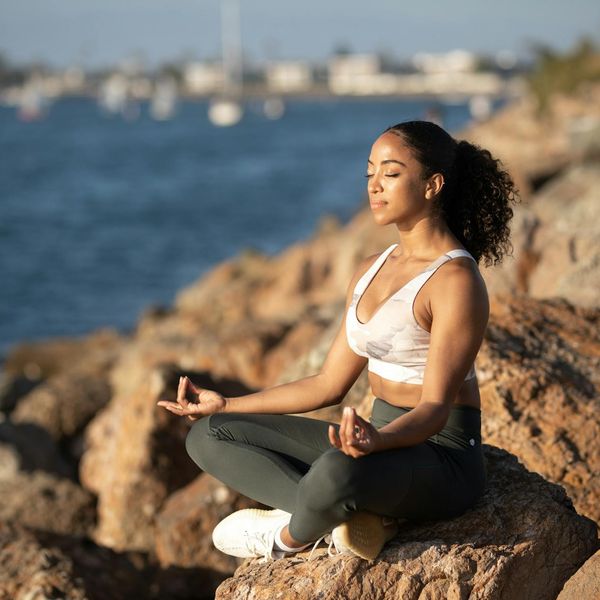 Person sitting in a meditative yoga pose, symbolizing balance and peace.